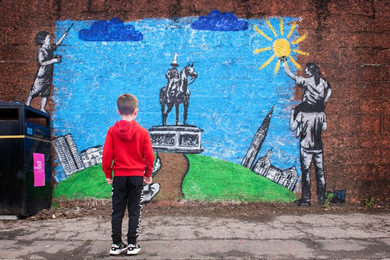 Community Ownership Hub - child looks at mural