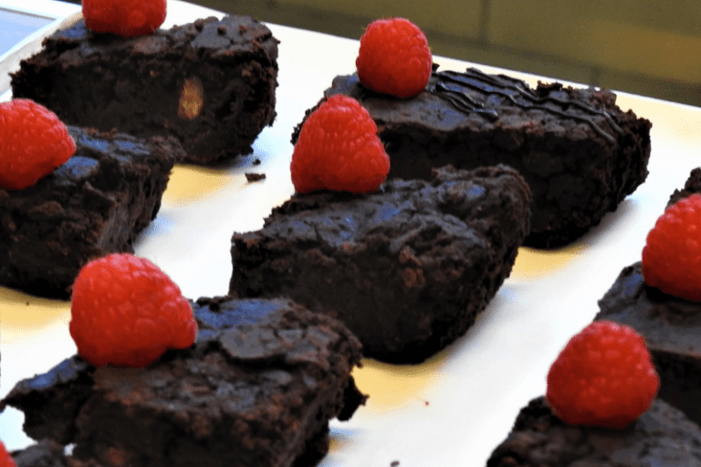 Community Ownership Hub - A plate of dark chocolate brownies each with a raspberry on top
