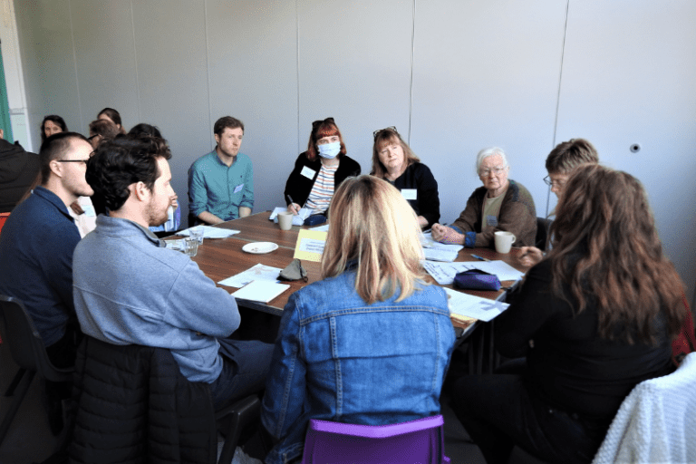 Community Ownership Hub - A group sit at a table
