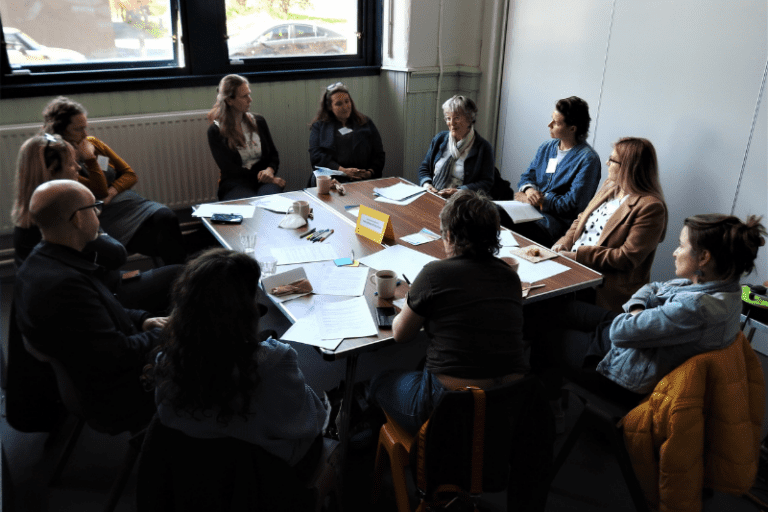 Community Ownership Hub - a group sits at a table